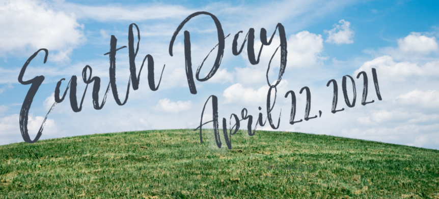 Blue sky white clouds and green grass with text Earth Day April 22 2021