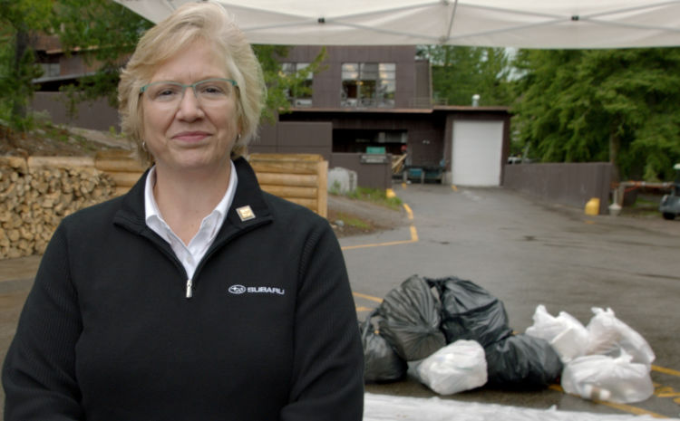 Denise Coogan of Subaru next to bags full of trash