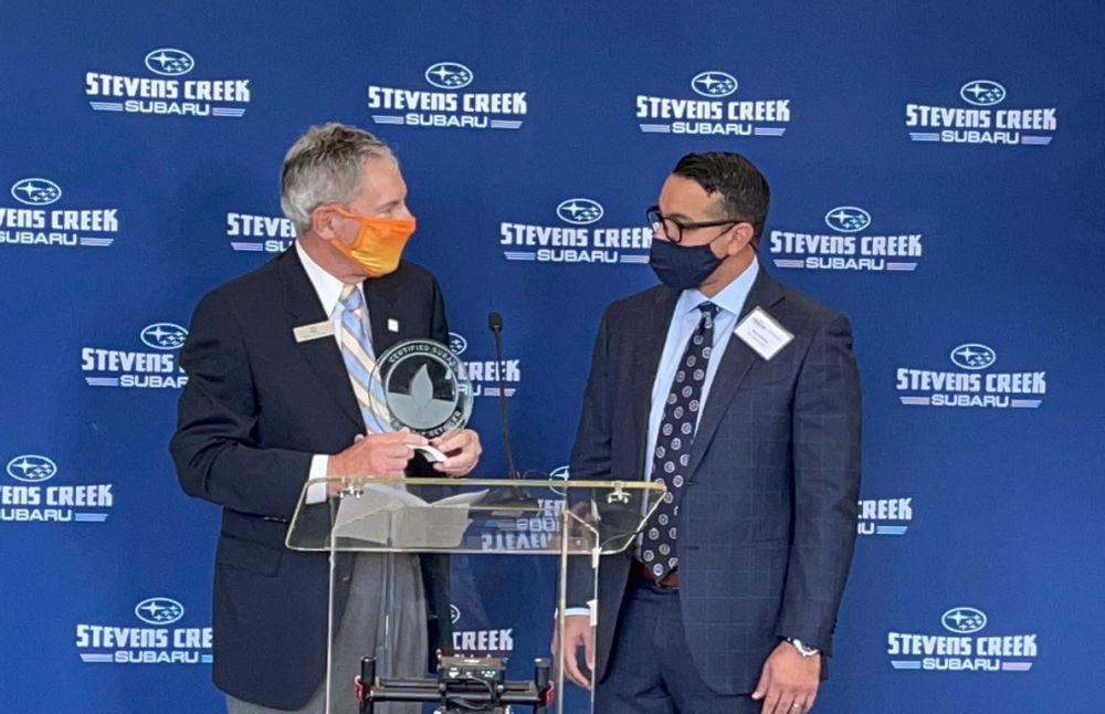 SOA CEO Tom Doll presents Eco-Friendly Retailer trophy to Stevens Creek management