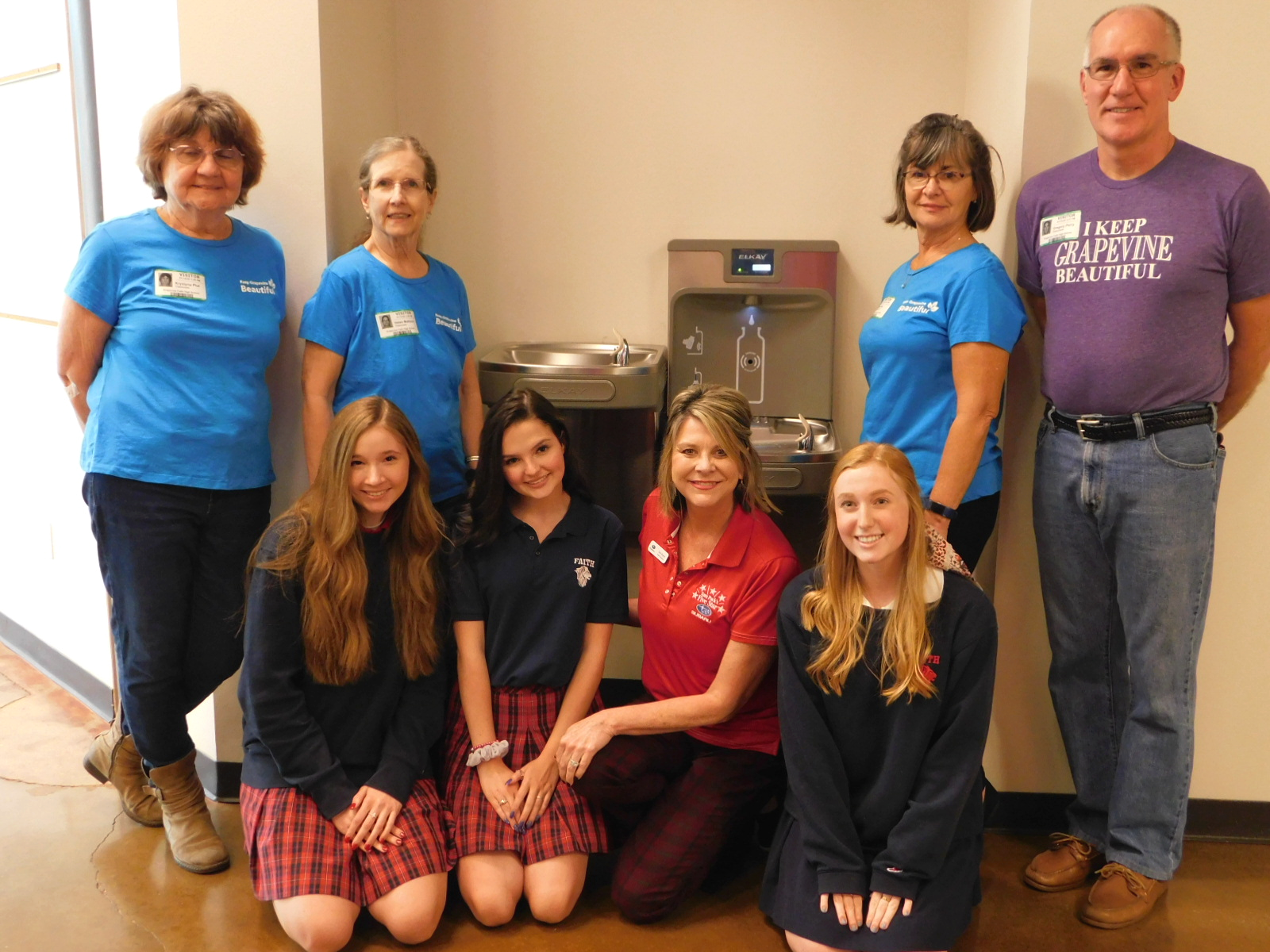 Group of students and others next to new bottle filling station